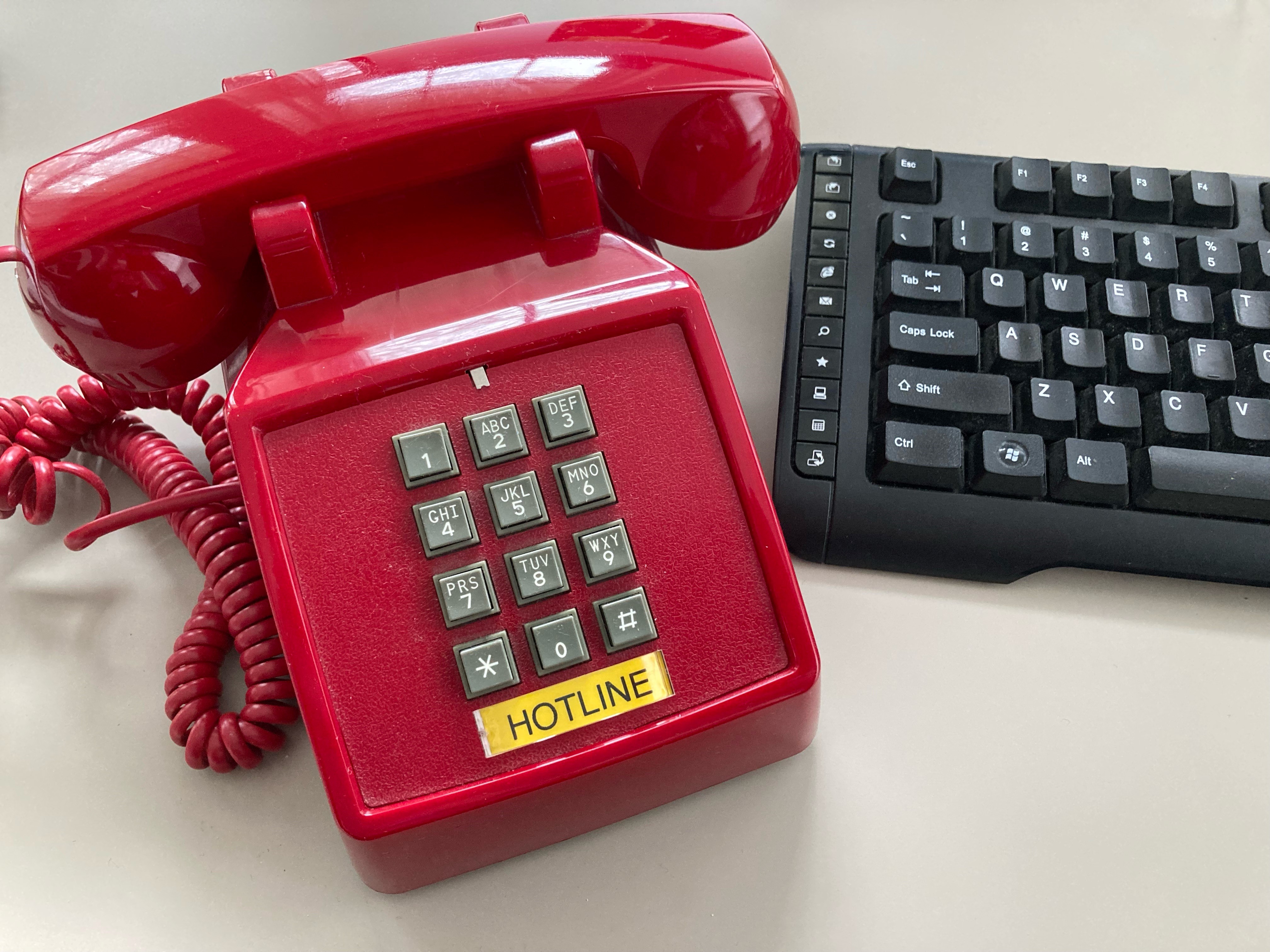 PG Calc hotline to our Client Services team - image of a red hotline phone